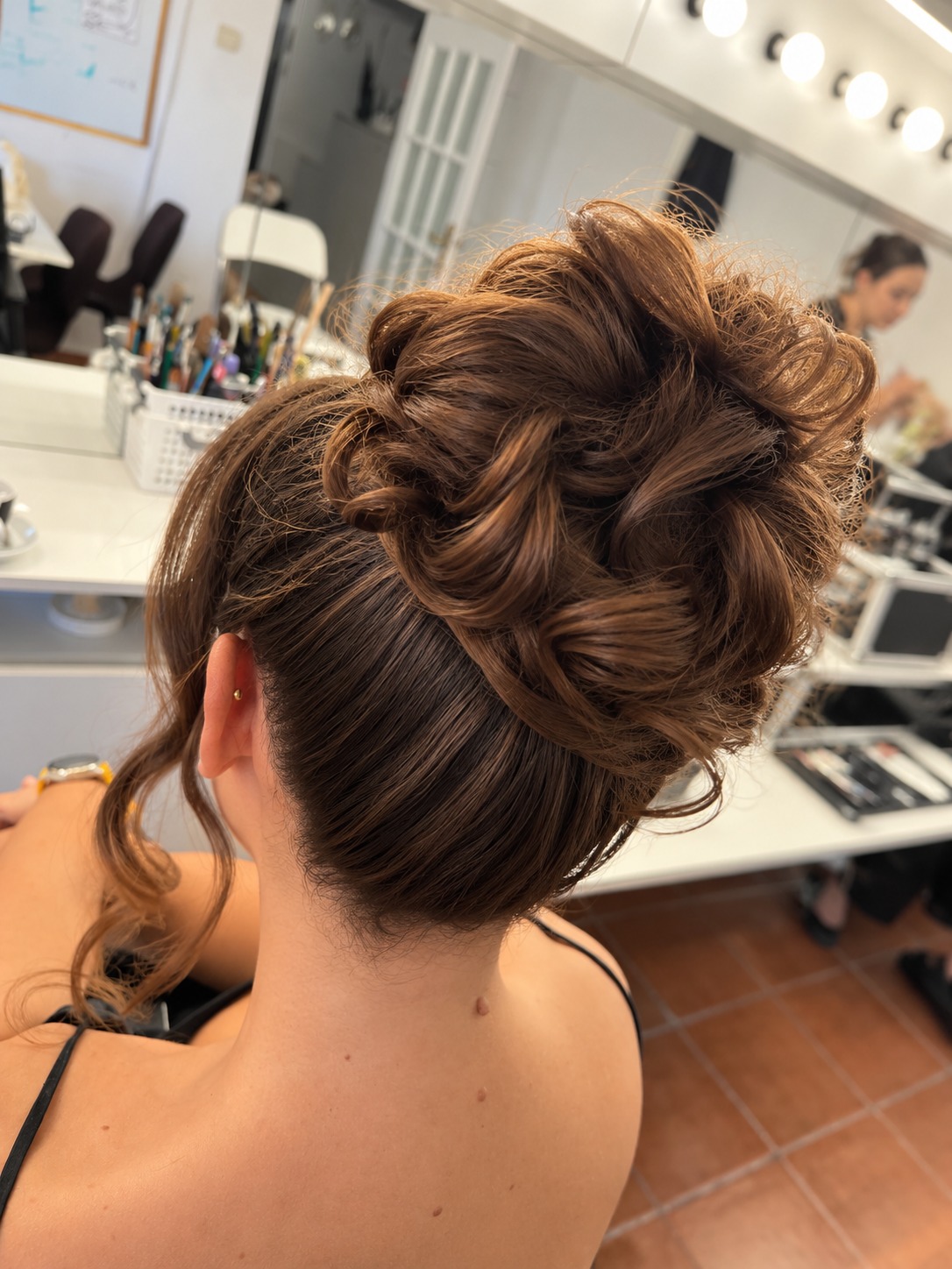A textured brown updo, rear view